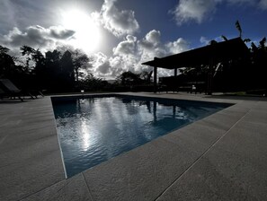 A swimming pool with a clear view of the sky and clouds.