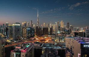A cityscape with high-rise buildings, including a prominent tower, and a busy road with lights. - Holiday Inn Dubai Business Bay by IHG (Dubai)