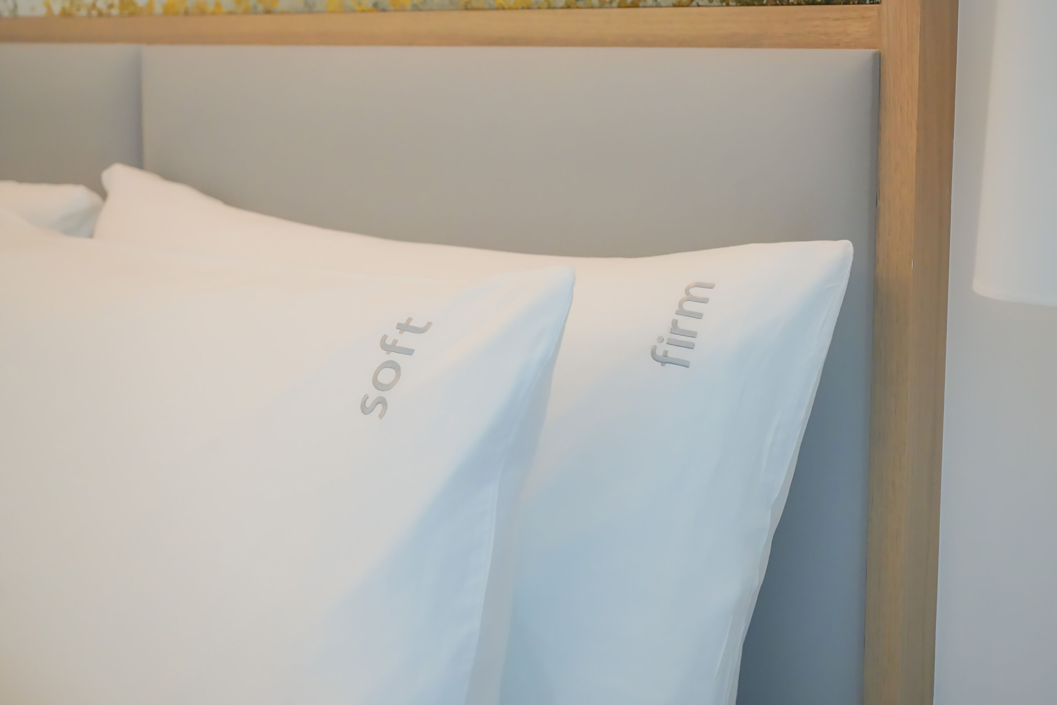 A bed with pillows labeled "soft" and "firm".