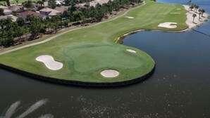 A golf course with a water hazard and a lake. - Luxurious golf home with pool in prestigious Colonial Country Club + Amenities (Fort Myers)