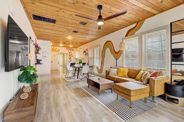 Relax in this spacious living area with a sofa, coffee table, and TV stand, perfect for unwinding after a long day.