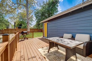 Relax on the deck with a grill station and comfortable wicker sofa.