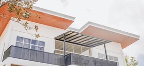 A modern building with a balcony, large windows, and a covered outdoor area. - Fight Club Philippines (Puerto Princesa)