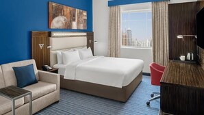 A hotel room with a large bed, a sofa, a desk, and a television. - Standard Room Near Safa Park with Free Breakfast (دبي)