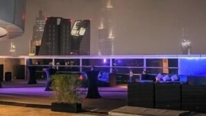 A pool area with a view of a tall building in the background. - Deluxe Room Near Financial Centre (دبي)