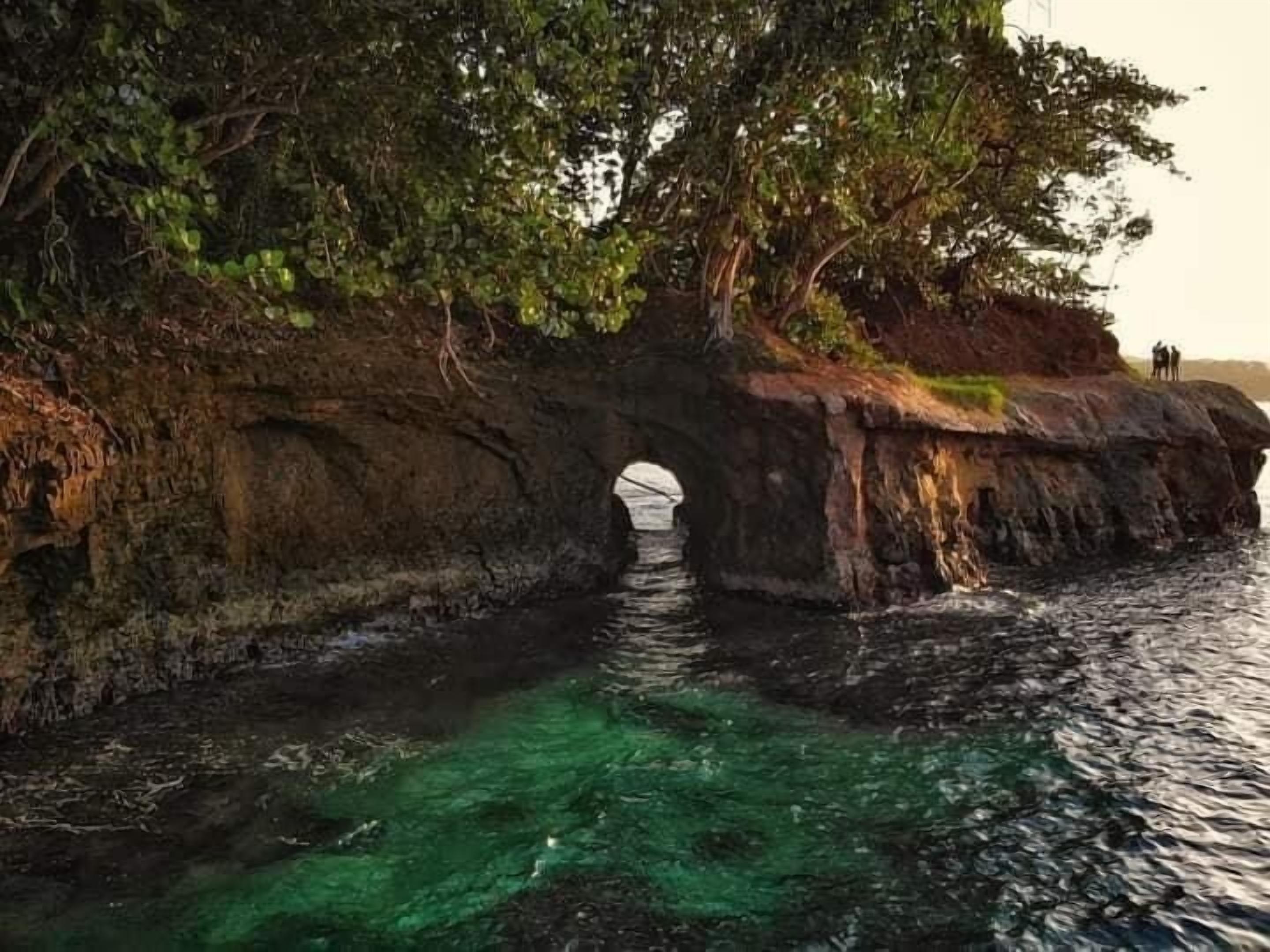 A natural rock formation with a clear water passage.