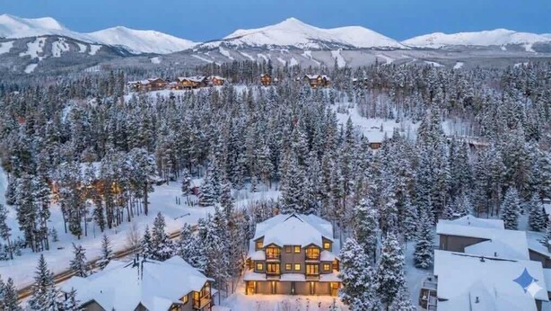 A lodge with multiple buildings surrounded by snow-covered trees and mountains in the background. - Updated 3BD-3 Blocks to Gondola! (Breckenridge)