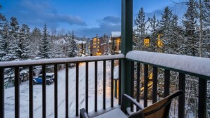 A snowy balcony with a view of a building complex and a snow-covered road. - Updated 3BD-3 Blocks to Gondola! (Breckenridge)