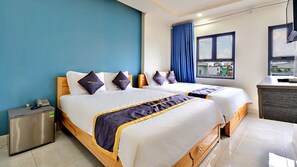 A hotel room with two beds, a desk, a phone, and a view of the outside. - HANZ Minh Thu Hotel Tan Binh (Ho Chi Minh City)
