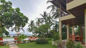 A resort with a pool, outdoor seating, and a view of the ocean. - A quiet oasis in the traditional north of Bali right by the sea (Kubutambahan)
