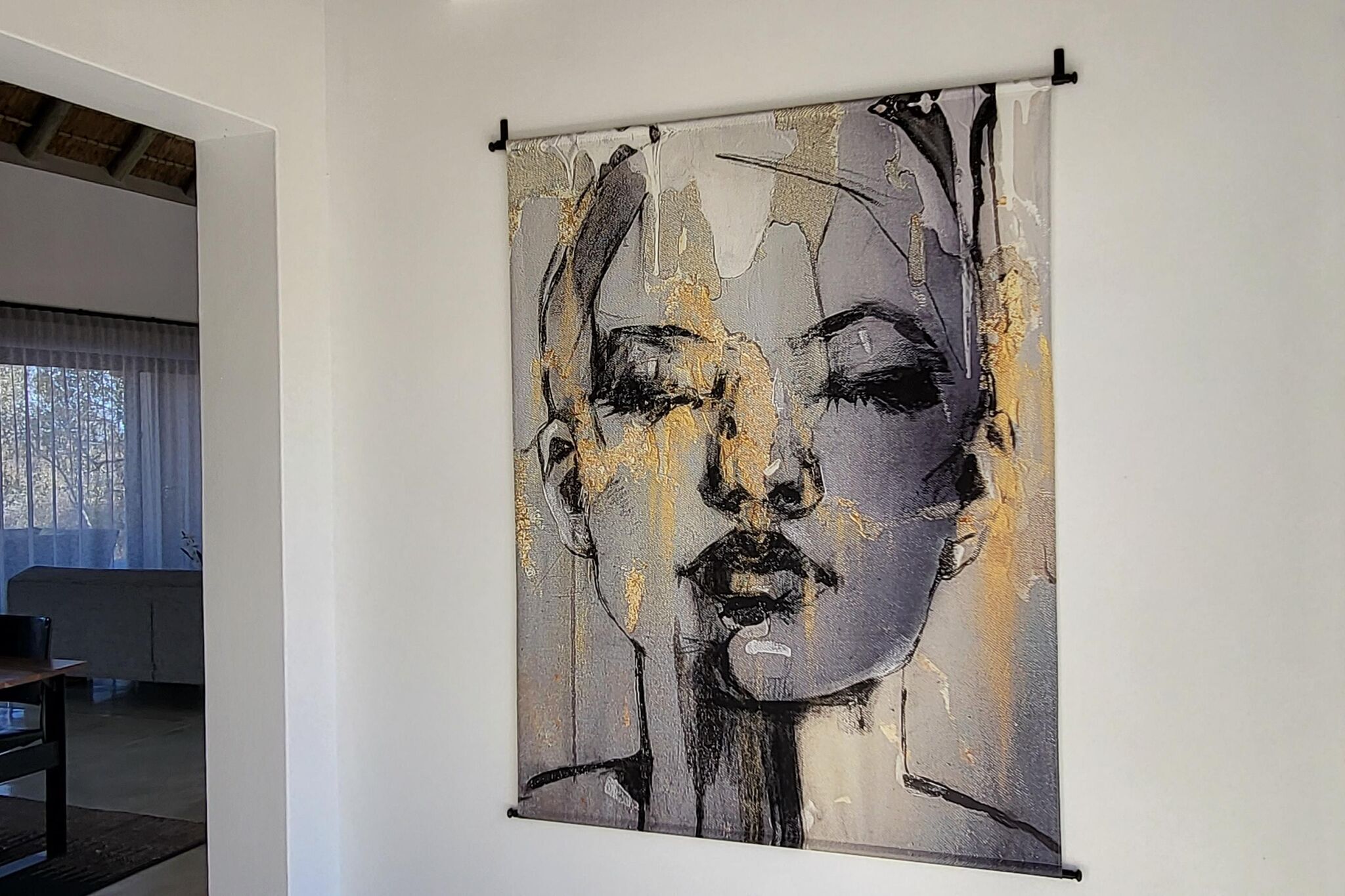 A modern interior with a large abstract painting on the wall.