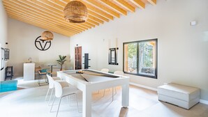 A modern room with a pool table, white furniture, a large window, and a wooden ceiling. - Villa "Son Simo D'Alt" with Mountain View, Private Pool & Wi-Fi (Crestatx)