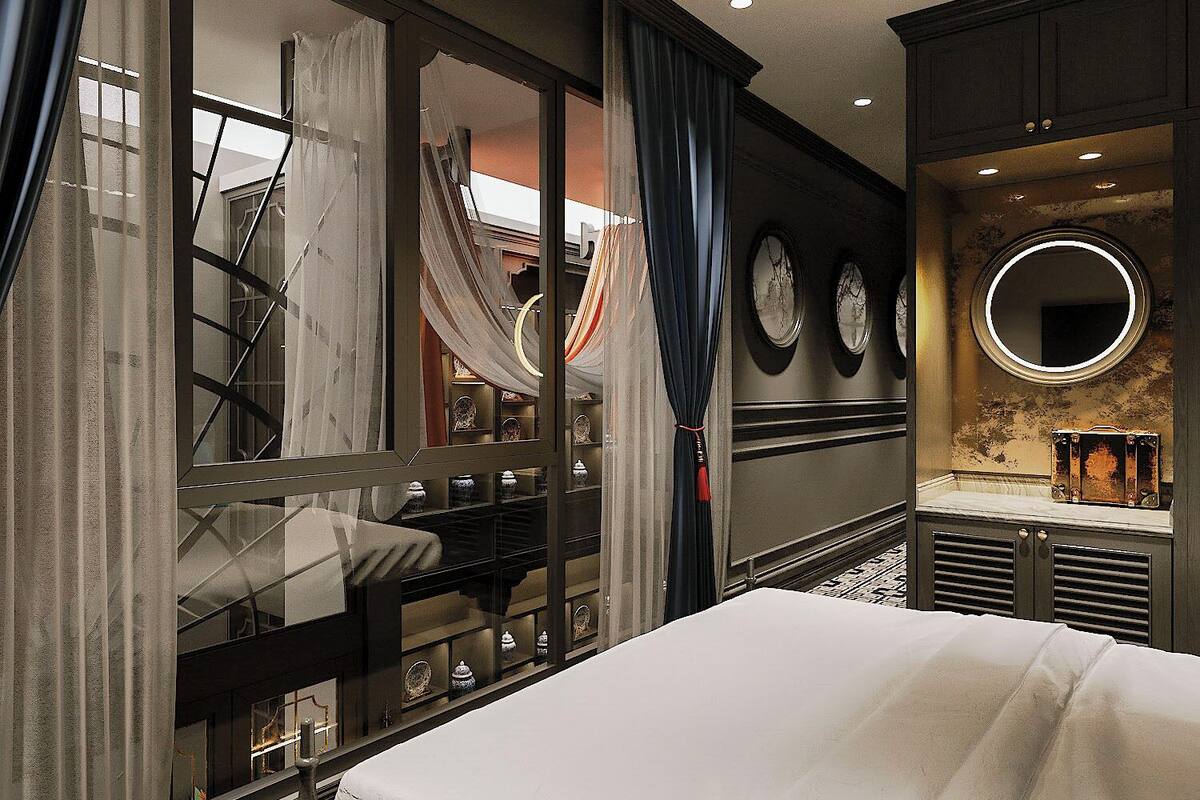 A hotel room with a large bed, a vanity with a mirror, and a view of a balcony with curtains.