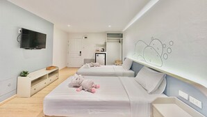 A modern hotel room with two beds, a flat-screen TV, a small kitchenette, and a bathroom visible through an open door. - Herma Hotel (Bang Phli)