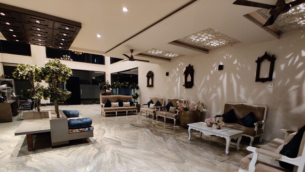 A spacious lobby with a high ceiling, marble flooring, and a variety of seating options including sofas and armchairs. - Chokar Dhani Raipur (Raipur)
