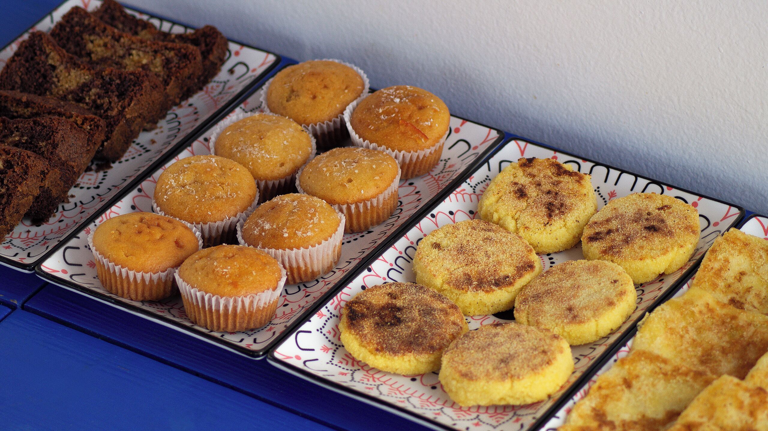 A tray of assorted baked goods including muffins and bread.