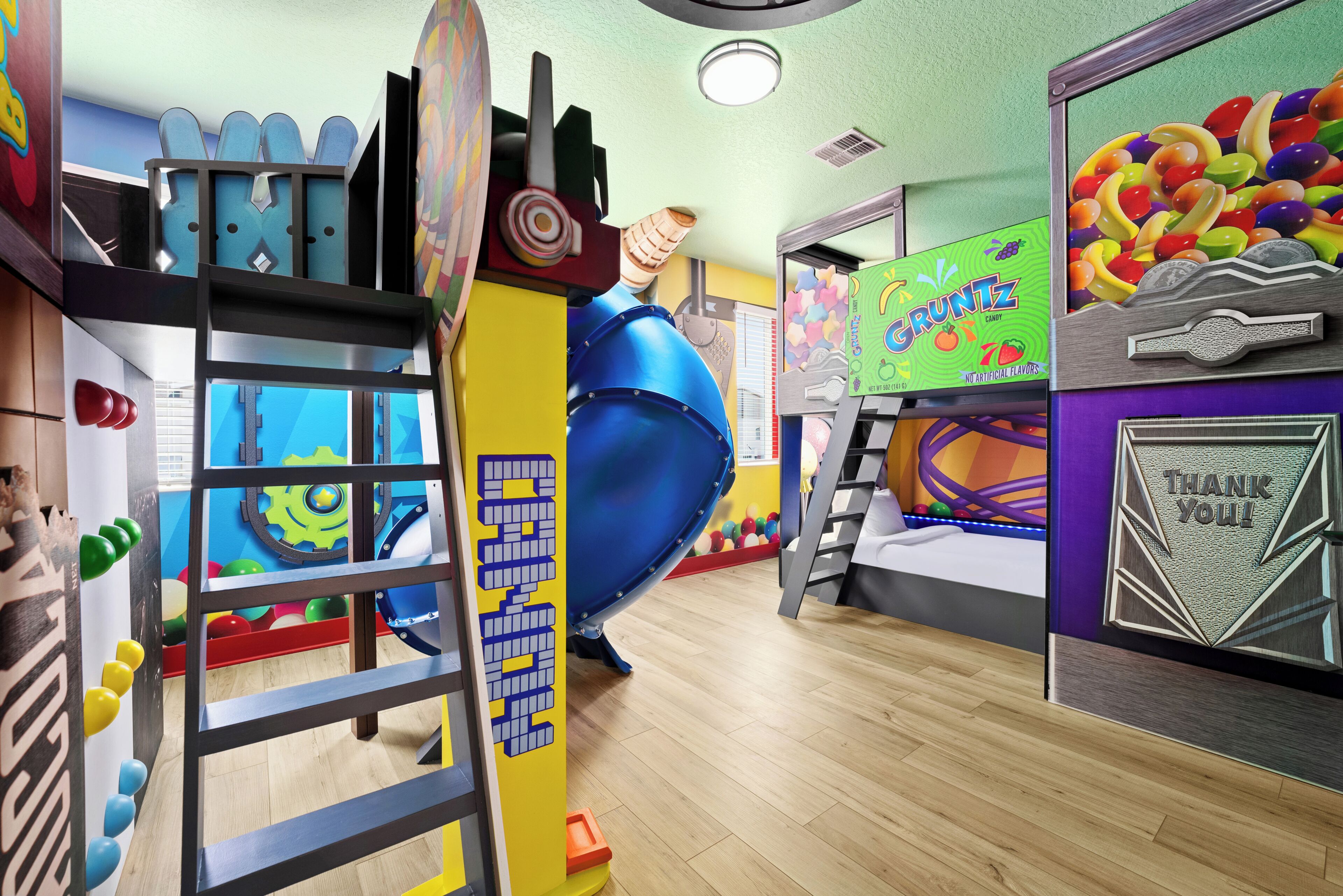A children's play area with a slide, climbing wall, and various play structures.