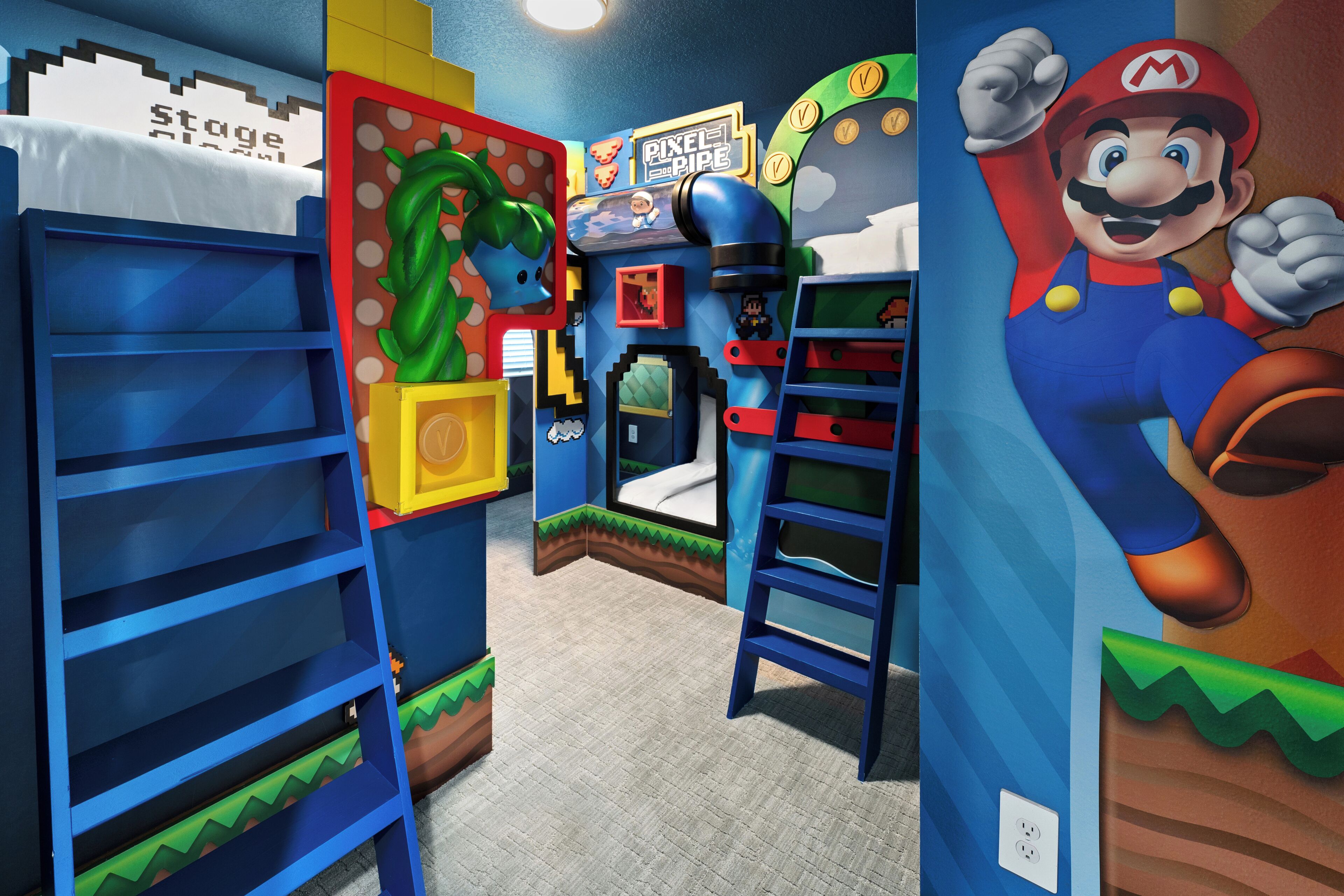 A room with a Mario-themed wall, a stage sign, and a Pixel Pipe game.