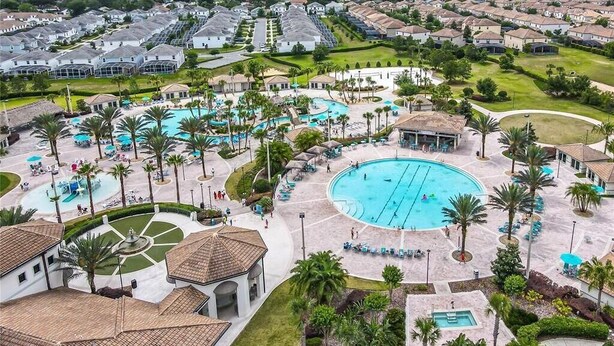 A resort with multiple swimming pools, palm trees, and a large central pool. - Waterpark Enclave with Epic Game Room! Prvt Movie Theatre! Themed Luxury! (Davenport)