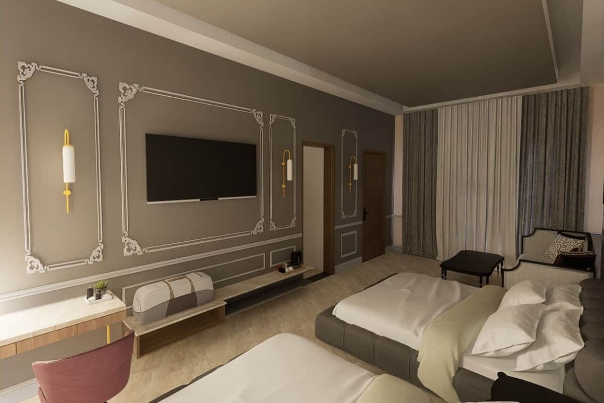 Une chambre d’hôtel moderne dotée d’un grand lit, d’un bureau, d’une télévision et d’un coin salon avec des rideaux.