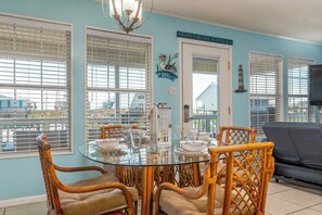 Relax in style with a round dining table and comfortable wicker chairs.