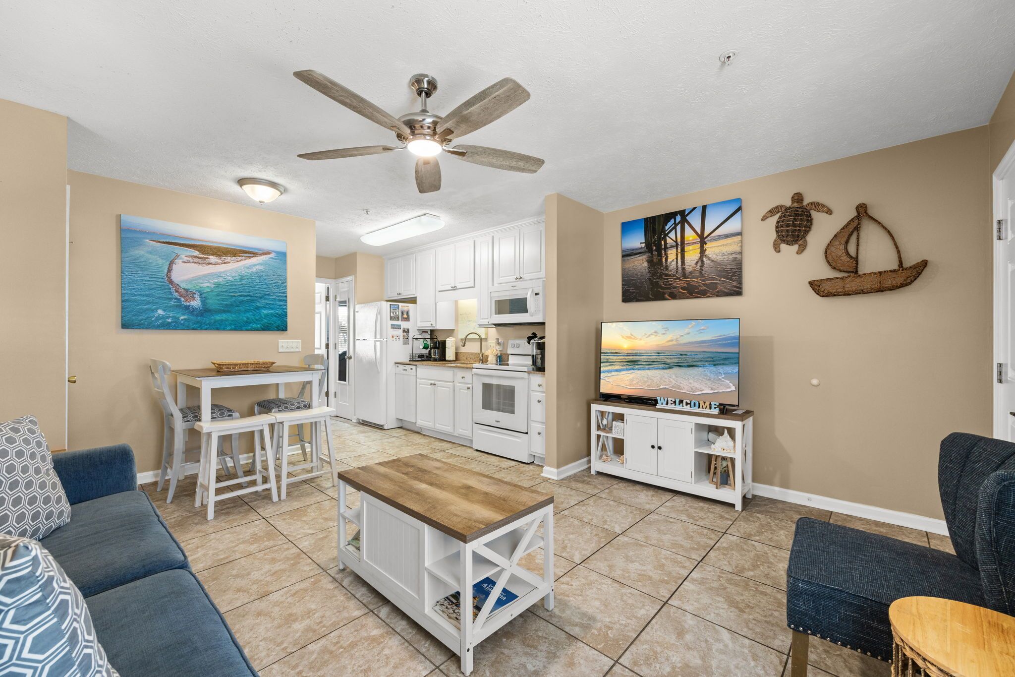 A compact living space with a kitchenette, dining area, and seating.