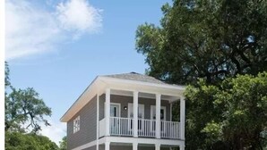 A two-story house with a front porch and a covered balcony. - Practically Perfect Place in Every Way (Pensacola)
