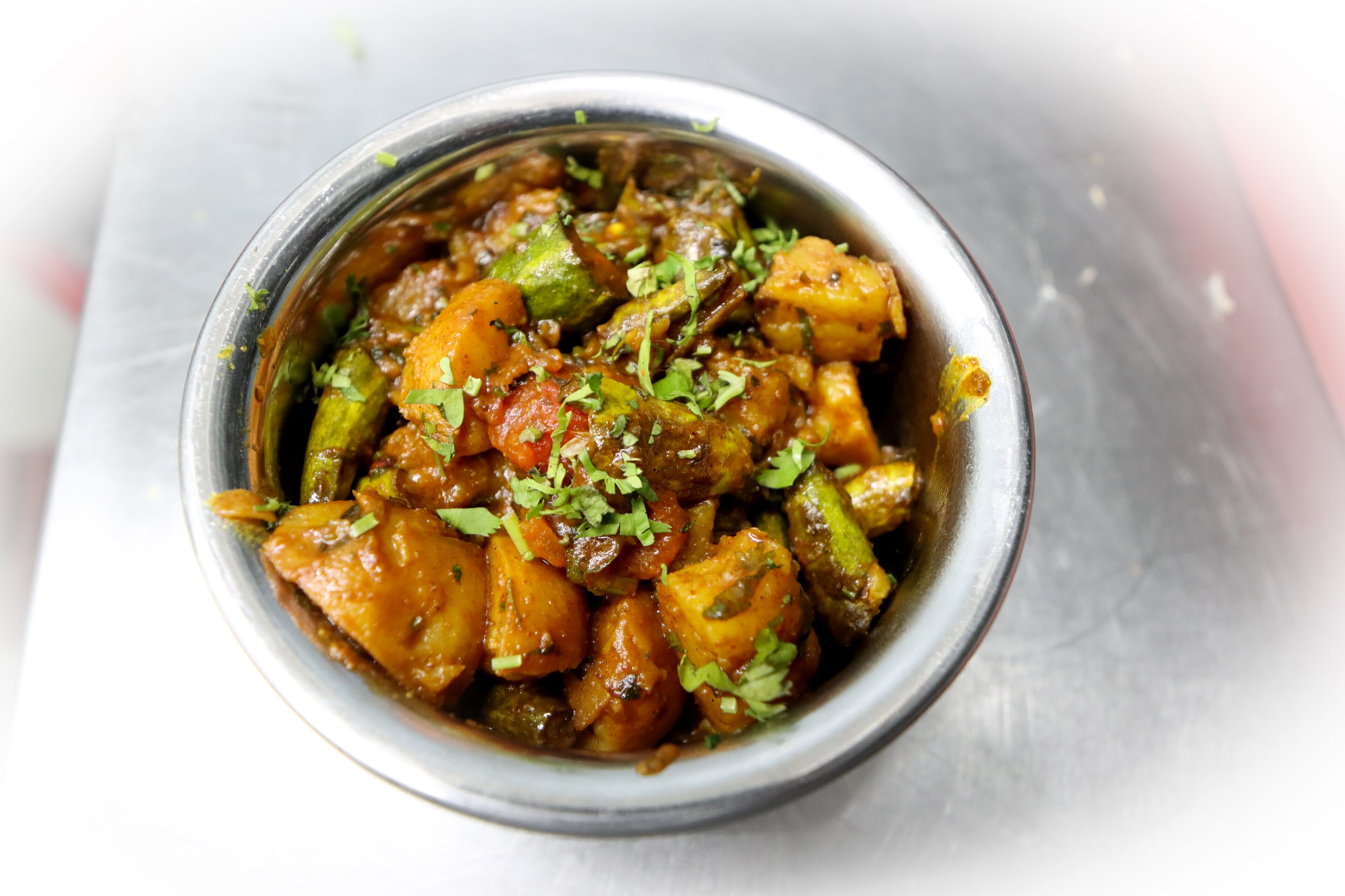 Eine Schüssel Gemüsecurry mit sichtbaren Kräutern.