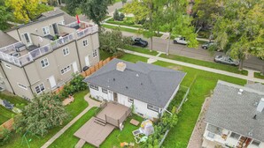 A two-story house with a fenced backyard, a patio, and a garage. - Urban Nest 7 mins from Edmonton downtown <br> (Edmonton)