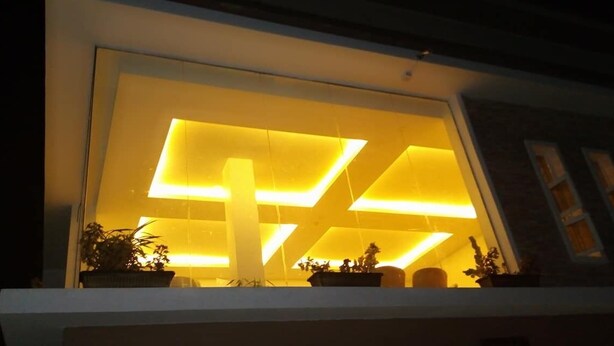 A modern building with illuminated interior lighting. - Novel Suites And Resort (Jos)