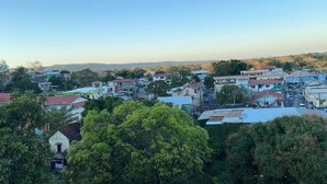 Un barrio residencial con casas, algunas con techos rojos, rodeado de vegetación y árboles.