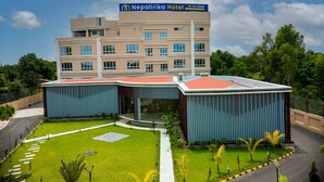A hotel with a modern design, featuring a prominent sign for the Nepalirika Hotel by PLO Group. The building has multiple floors with large windows and a flat roof. - Nepalirika Hotel Biratchowk (Sundar Haraicha)