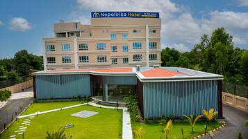Experience the Nepalirika Hotel's elegant facade, featuring a symmetrical design with multiple windows and balconies.