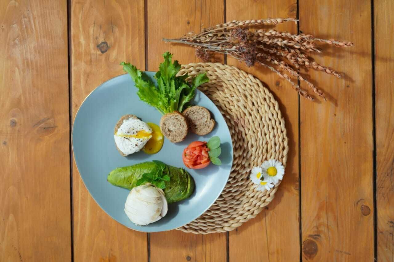 Een bord met eten op een houten tafel.