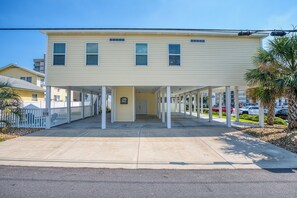A two-story building with a covered entrance and a sign indicating it is a motel. - 4BD Ocean View Private Beach Home -Heated Saltwater Pool- Elevator (North Myrtle Beach)