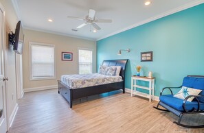 A bedroom with a bed, a rocking chair, a ceiling fan, and a window with blinds. - 4BD Ocean View Private Beach Home -Heated Saltwater Pool- Elevator (North Myrtle Beach)
