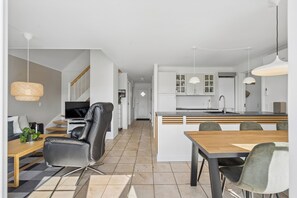 A modern interior with a dining area, kitchen, and living space.
