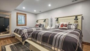 A bedroom with a large bed, a bedside table, a nightstand, a window, and a door. - Ski Side Getaway < 1 Mile From Mountain  (Tannersville)