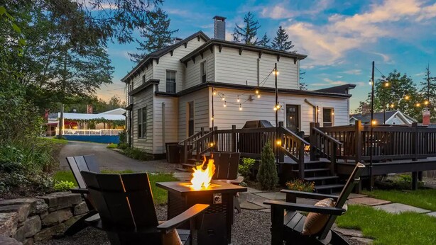 A house with a fire pit and outdoor seating.