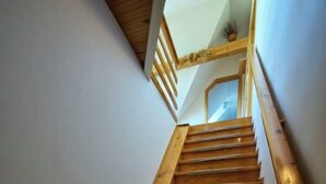 A wooden staircase with a handrail, leading to an upper floor. - Harrachov 497 by Interhome (Harrachov)