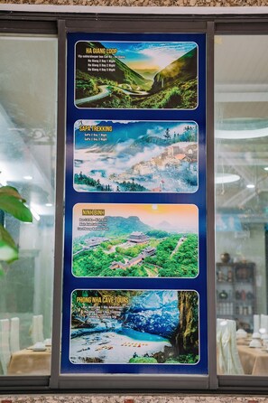 A travel information board with pictures of Ha Giang Loop, Sapa Trekking, Ninh Binh, and Phong Nha Cave Tours. - Phuong Dong Hotel (Hai Phong)