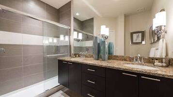 Bathtub, hair dryer, towels, shampoo