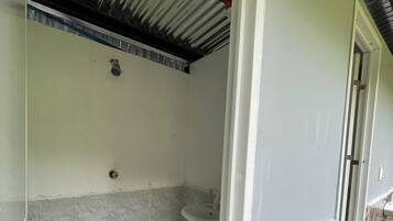 A bathroom with a toilet, sink, and shower area.
