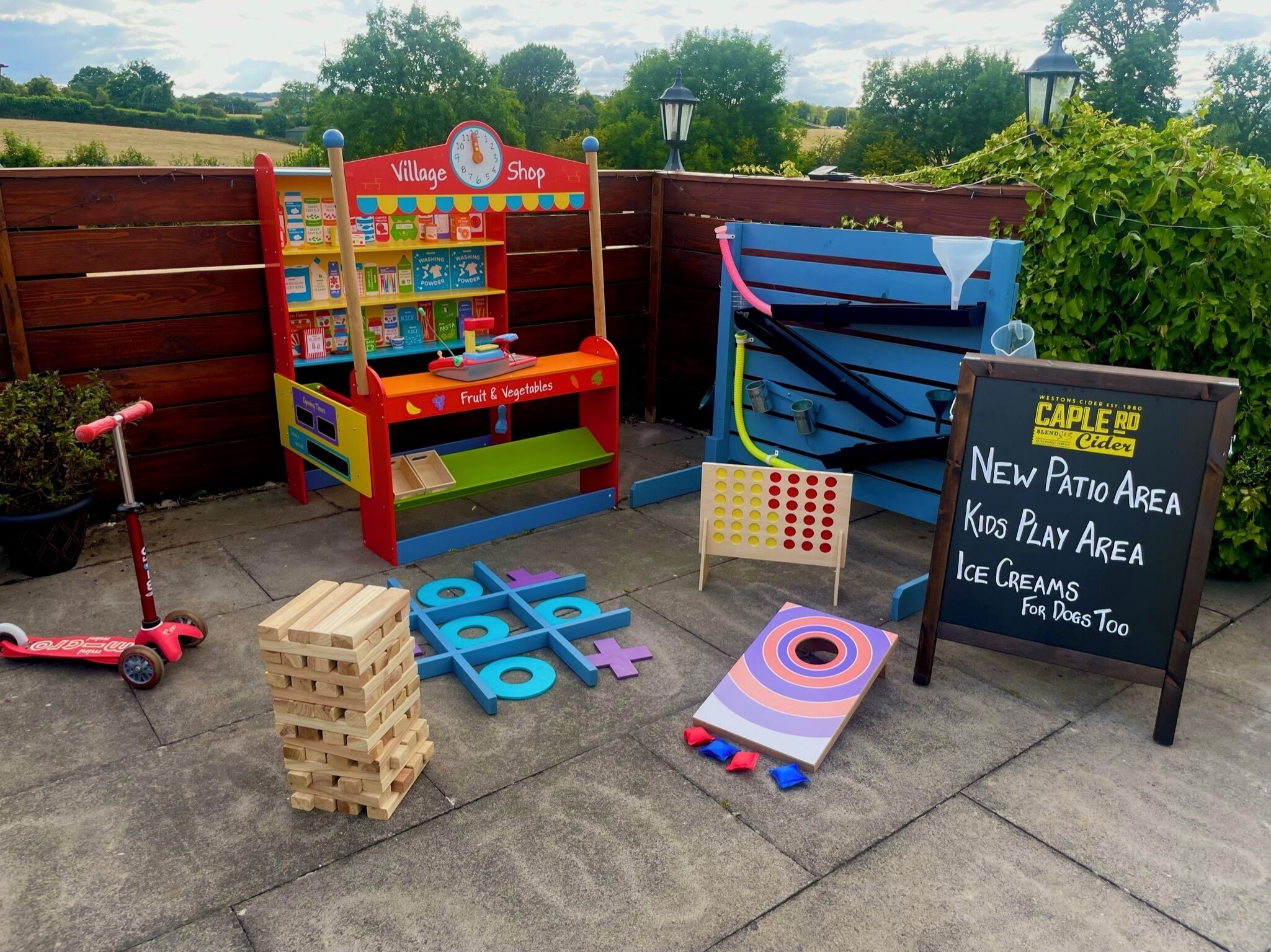 A children's play area with a Village Shop, a new patio area, and an ice cream stand.