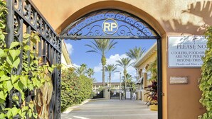An entrance gate with a sign indicating 'Registered Guests only beyond this point.' - 4BR Regal Palms | Lazy River, Slide + Arcade (Davenport)