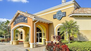 A building with two signs: "Regal Palms Bar, Restaurant, Spa" and "Frankie & Frankie Pub & Grill". - 4BR Regal Palms | Lazy River, Slide + Arcade (Davenport)
