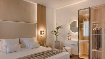 A modern hotel room with a large bed, a bedside table, a potted plant, a round mirror, and a sliding wardrobe.