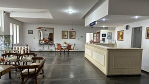 A spacious lobby with a reception desk, seating area, and a large mirror. - HOTEL PLATINO (Sao Lourenco)