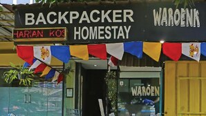 A storefront with a sign reading "BACKPACKER HOMESTAY" and "HARIAN KOS". - Backpacker Homestay Cibubur by PEKOTEL (Bekasi)