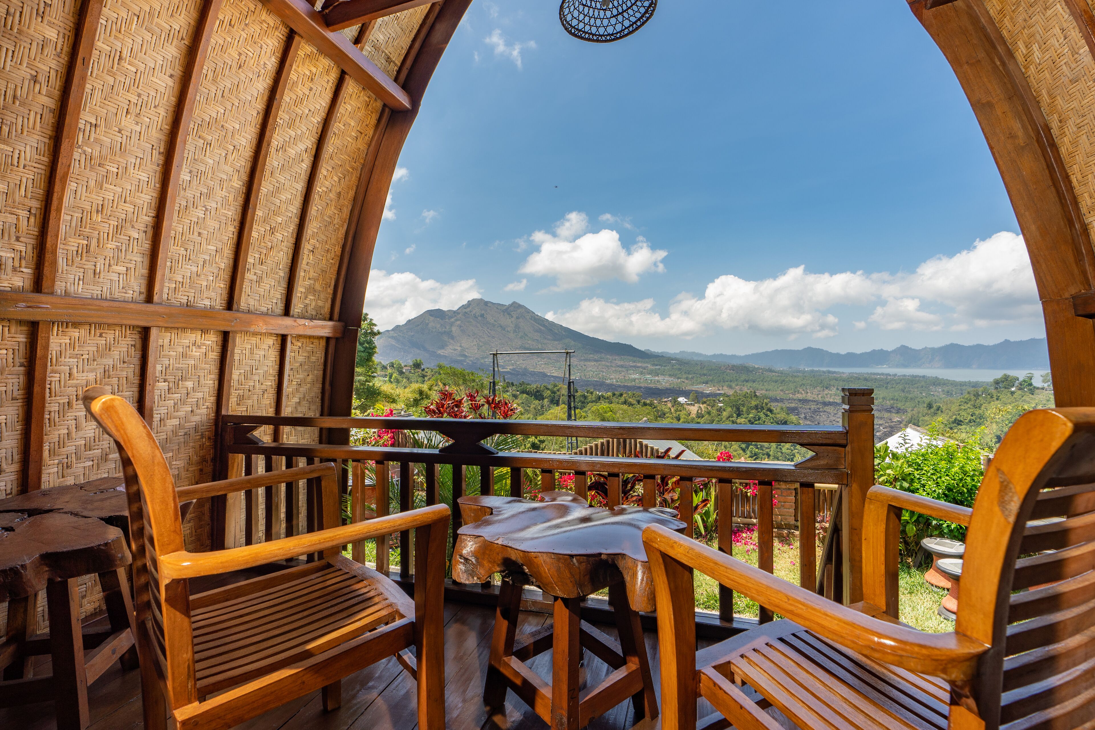 Eine Holzterrasse mit Tisch und Stühlen mit Blick auf eine Berglandschaft.